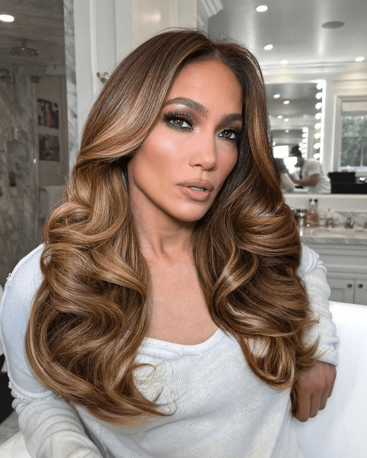 JLO in a bathroom with bouncy voluminous curls